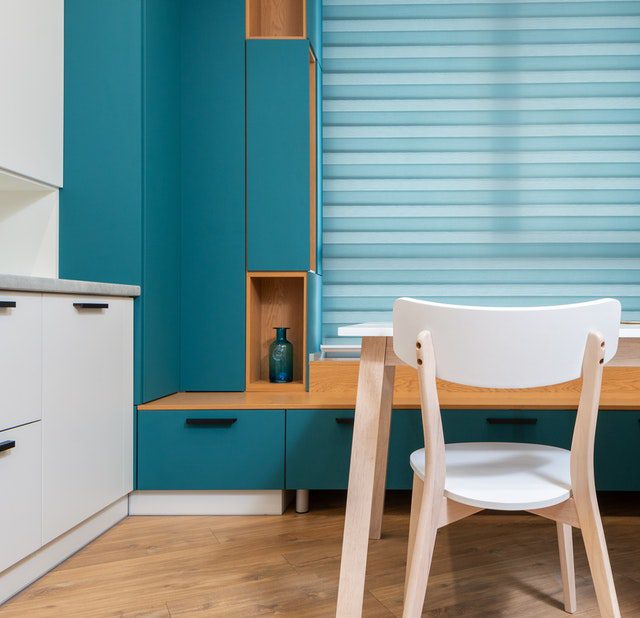 brightly painted room with light colored table and chair